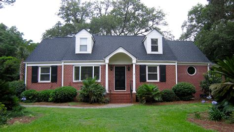 painted brick houses with metal roofs|brick and shingle combinations.